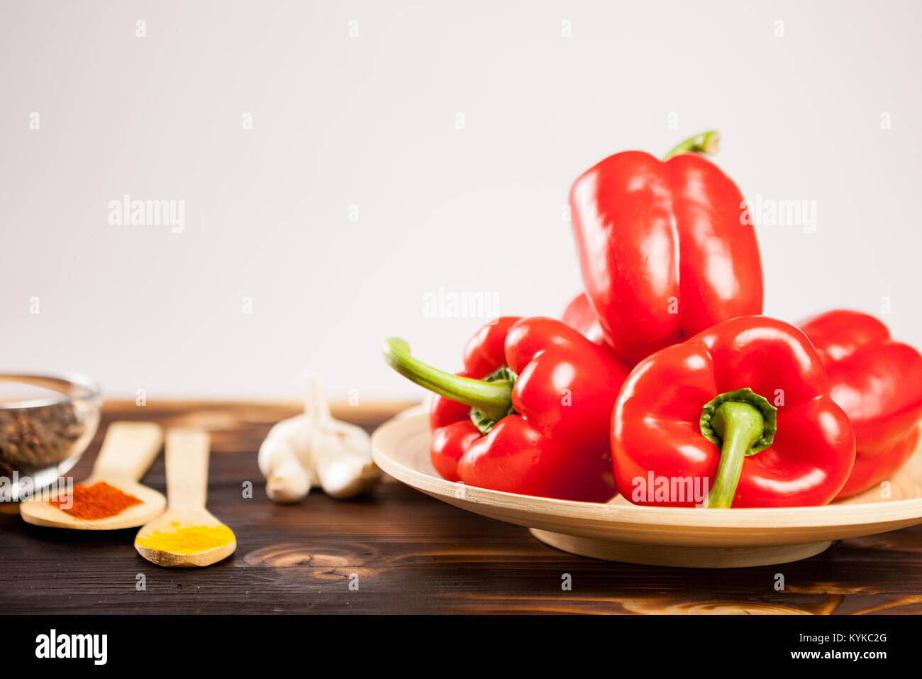 Sweet red peppers next to powder spices Stock Photo Alamy
