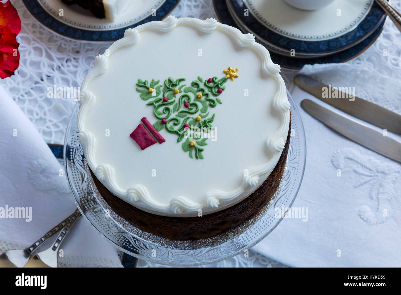 Fruit cake decorated on top with marzipan and royal icing and stencilled  Christmas Tree. Stock Photo