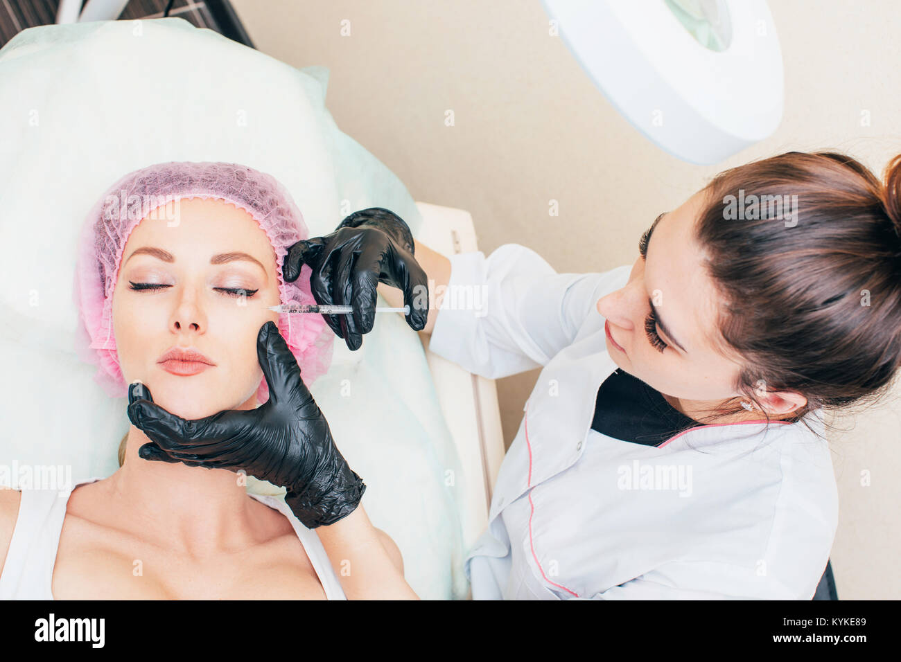 Cosmetic Treatment. Closeup Beautician Hands Doing Facial Skin Lifting Injection To Woman's Face. Receiving Beauty Procedure Indoors. High Resolution Stock Photo
