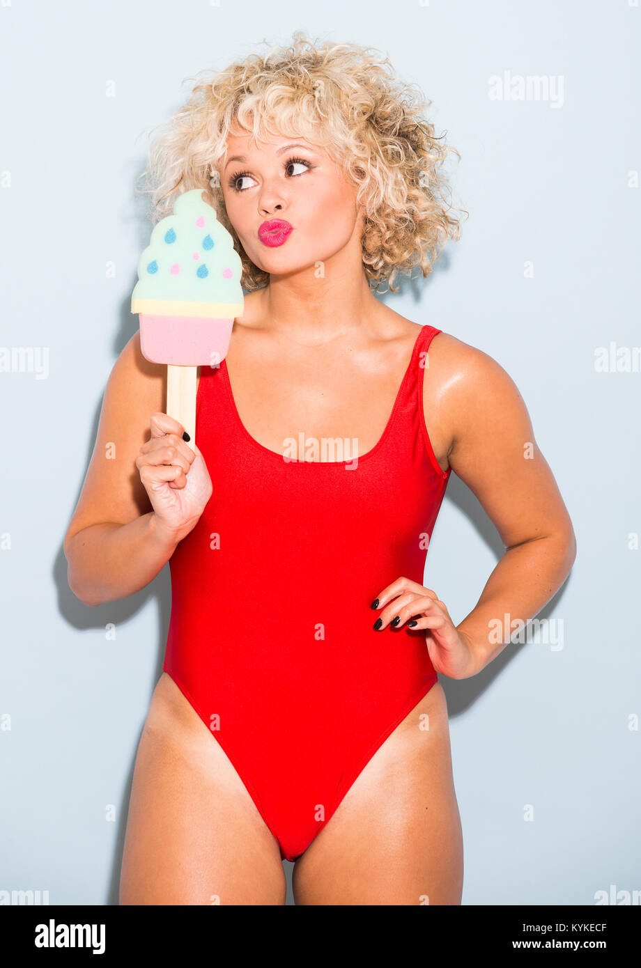 Savanna Love Island in red swimsuit with foam icecream sponge Stock