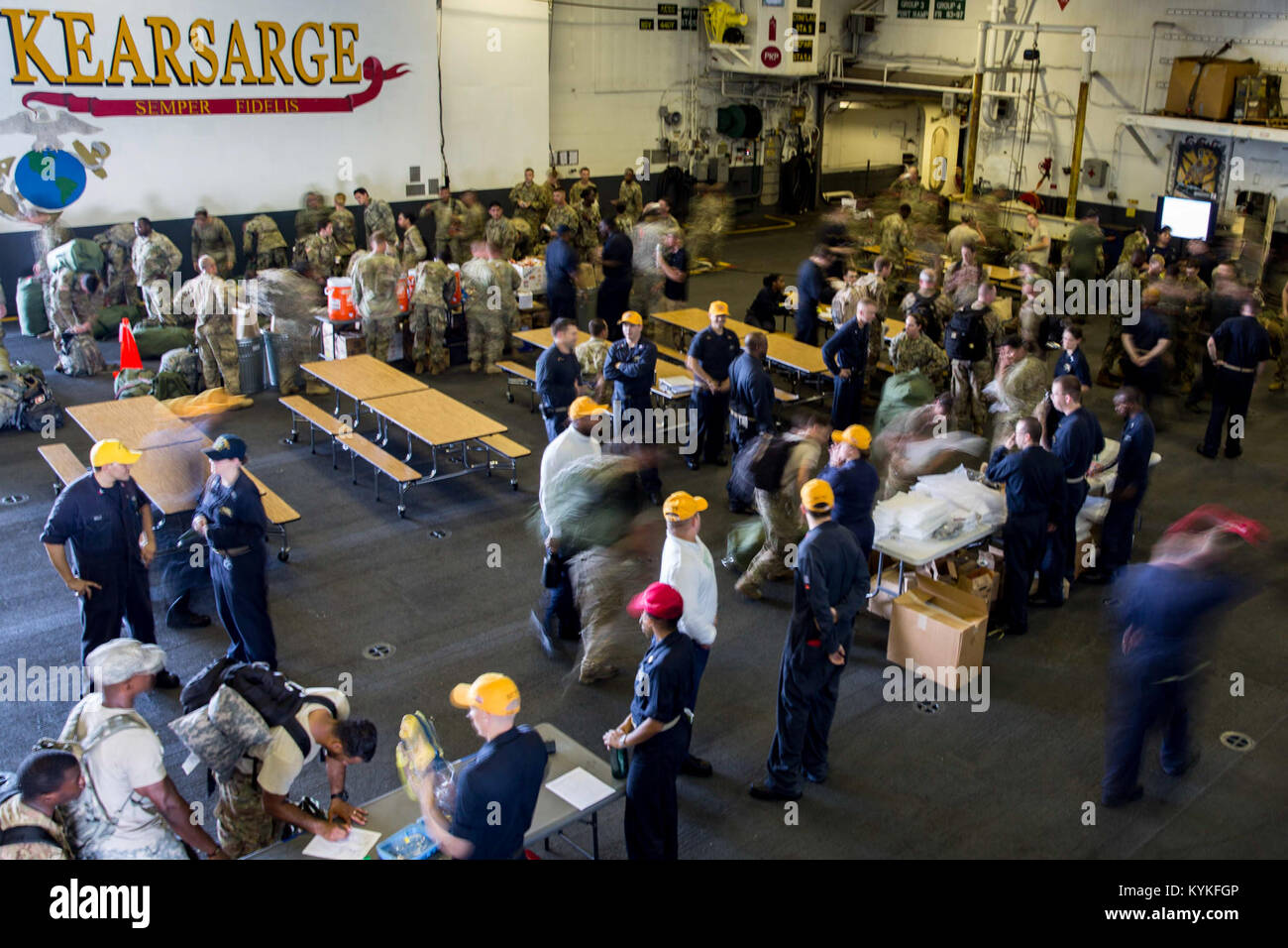 CARIBBEAN SEA (Sept. 17, 2017) Sailors assigned to the amphibious assault ship USS Kearsarge (LHD 3) process service members evacuated from St. Thomas, U.S. Virgin Islands, in anticipation of Hurricane Maria. Kearsarge is assisting with relief efforts in the aftermath of Hurricane Irma. The Department of Defense is supporting FEMA, the lead federal agency, in helping those affected by Hurricane Irma to minimize suffering and is one component of the overall whole-of-government response effort. (U.S. Navy photo by Mass Communication Specialist 3rd Class Ryre Arciaga/Released)170917-N-KW492-024 Stock Photo