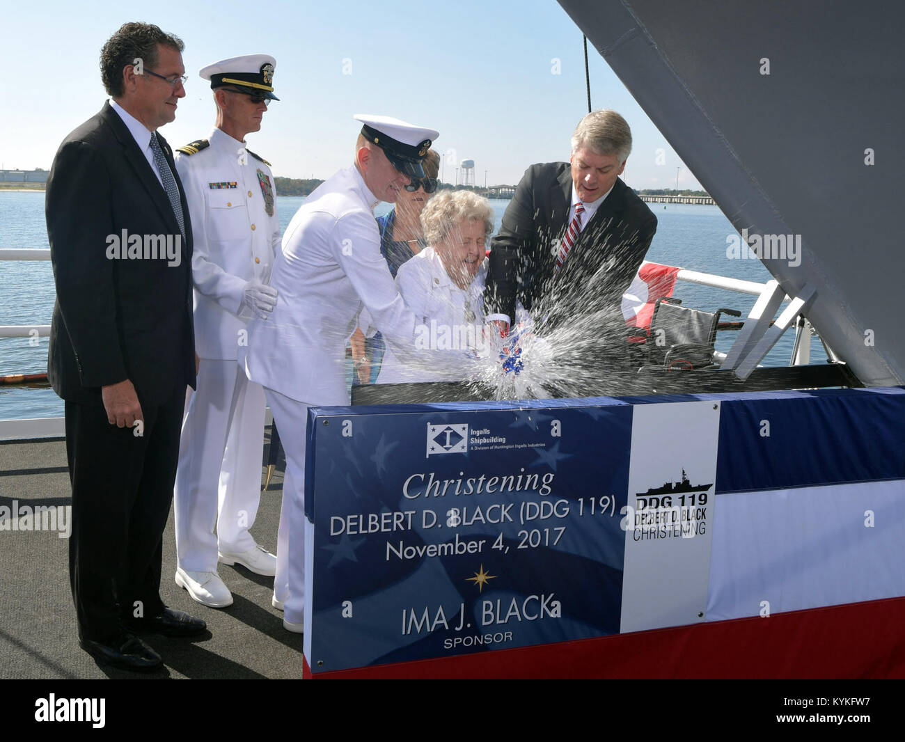 PASCAGOULA, Miss. (Nov. 4, 2017) Ship's Sponsor Ima J. Black christens DDG 119, the destroyer named for her late husband, Delbert D. Black, the first Master Chief Petty Officer of the Navy. Also pictured, left to right, are Rep. Gregg Harper, R-Miss.; Lt. Cmdr. Mark Gallagher, prospective executive officer, DDG 119; Master Chief Petty Officer of the Navy Steven S. Giordano; Marilyn Kendall, matron of honor; and Ingalls Shipbuilding President Brian Cuccias. (U.S. Navy photo courtesy Huntington Ingals Industries by Andrew Young/Released) 171104-N-NO101-001 Stock Photo