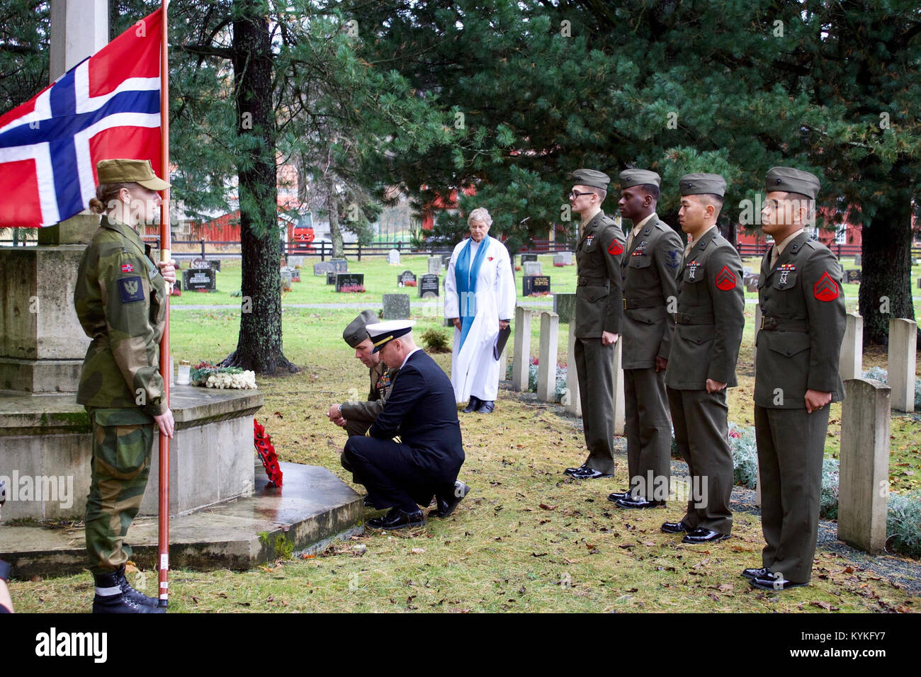 TRONDHEIM, Norway (Nov. 16, 2017) U.S. Marines and a Navy chaplain assigned to Marine Rotational Force Europe 17.2 place a wreath on a memorial site in Trondheim, Norway. The memorial is dedicated to all fallen soldiers from past and present conflicts. Events like this help the U.S. and Norway to preserve mutual commitment and trust in confronting evolving strategic challenges together. (U.S. Marine Corps photo by Lance Cpl. Jesus Flores/Released)171116-M-ZH337-101 Stock Photo