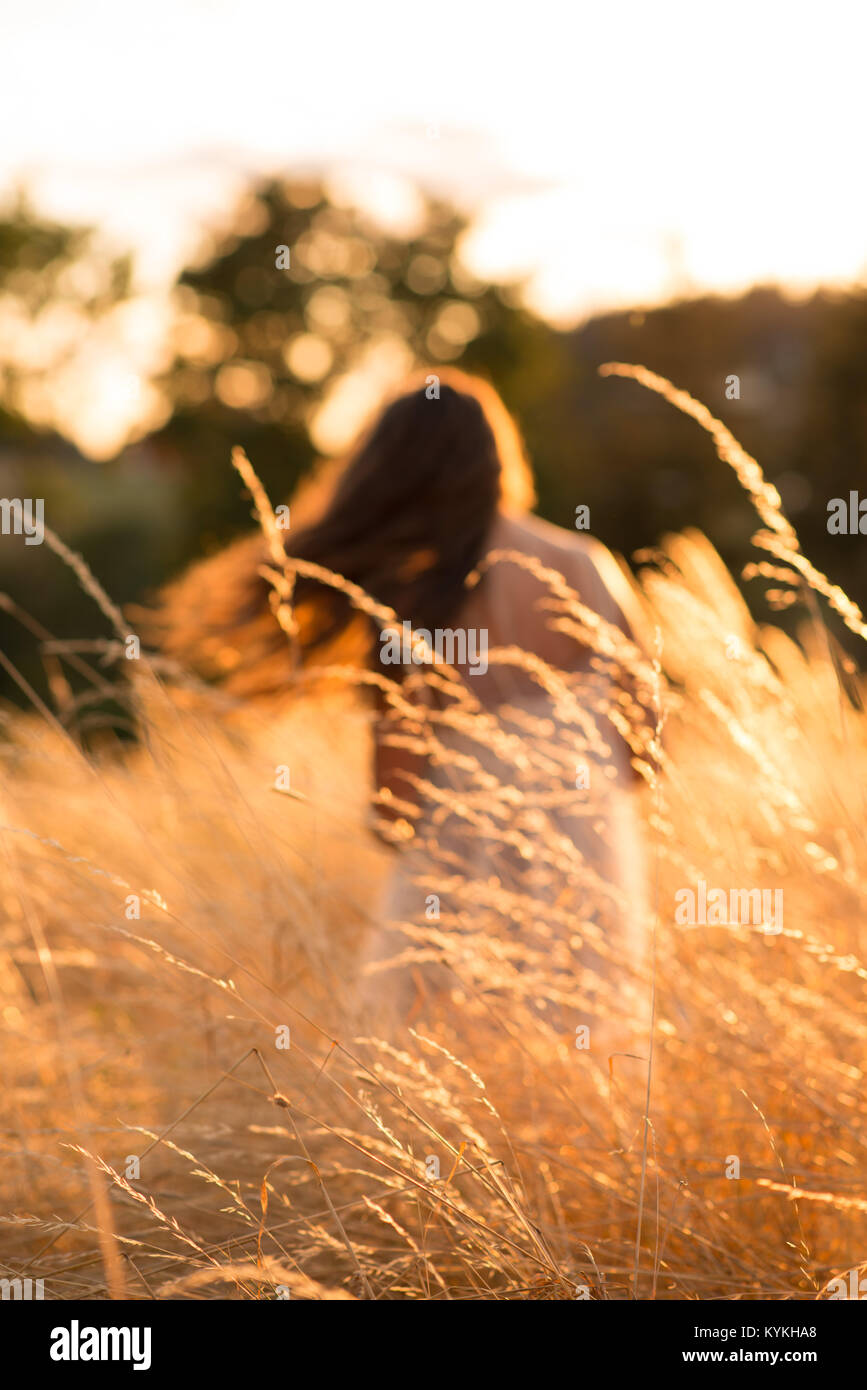 Girl Shaking Her Hair In Field Stock Photo