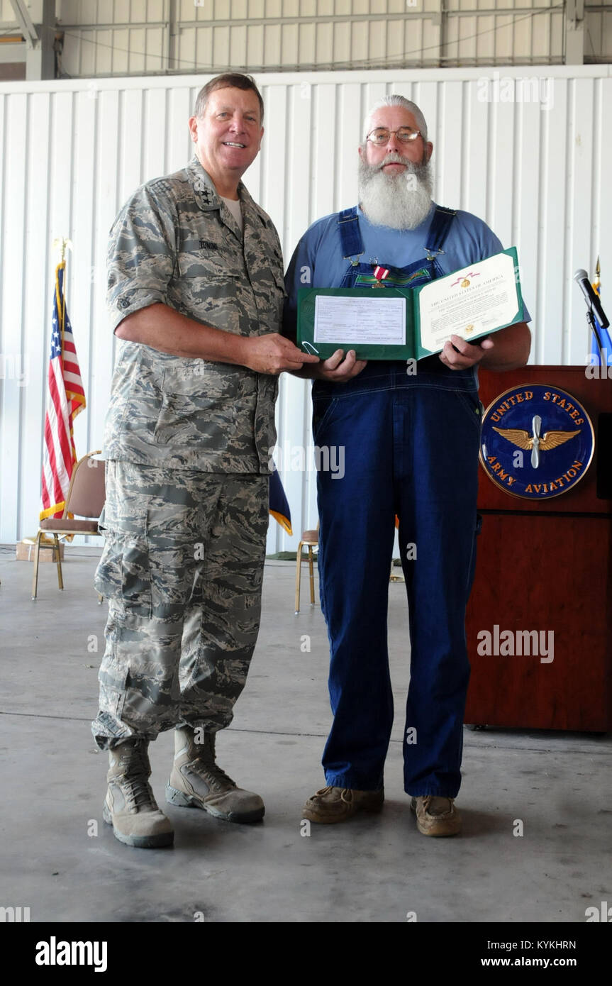 Kentucky's Adj. Gen., Maj. Gen. Edward Tonini, presents retired Master Sgt. Ronald Brandenburg,the meritorious service medal at an awards ceremony held July 9 at the Capital City Airport in Frankfort Ky.  (U.S. Army National Guard photo by Spc. Brandy Mort) Stock Photo