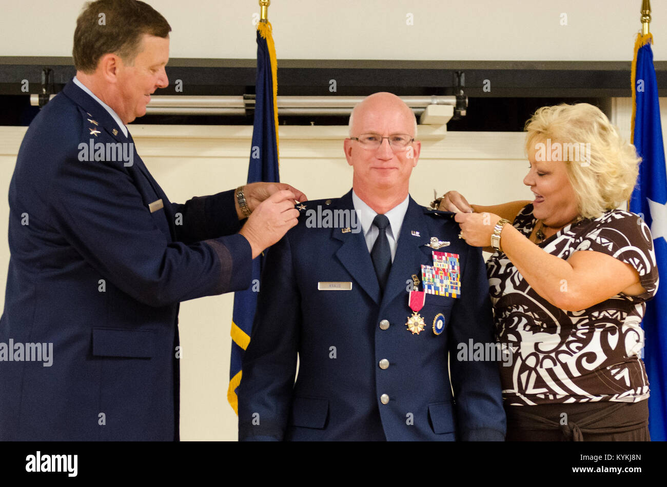 Maj. Gen. Mark Kraus’ wife (right) and Kentucky's adjutant general, Maj. Gen. Edward Tonini, pin the rank insignia of major general to Kraus’ uniform during a promotion ceremony at the Kentucky Air National Guard Base in Louisville, Ky., Aug. 18, 2013. Kraus is a Kentucky Air Guardsman who serves as Air National Guard assistant to the commander of U.S. Air Forces Central. (U.S. Air National Guard photo by Airman Joshua Horton) Stock Photo