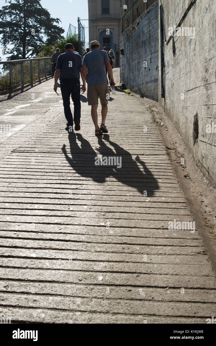 Men Walking Away Stock Photo