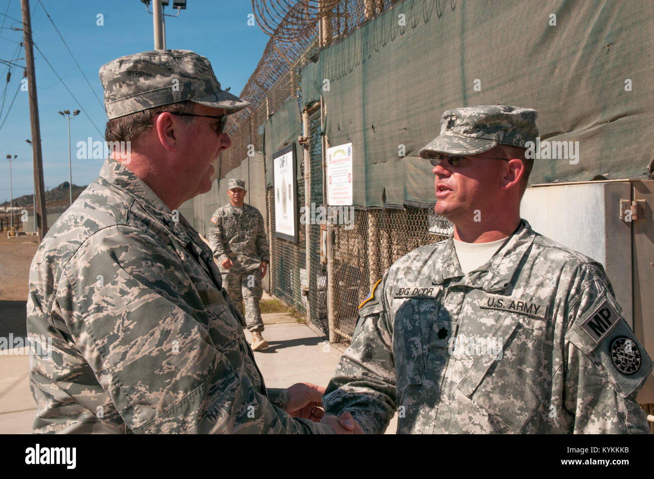 Air Force Maj. Gen. Edward Tonini, adjutant general for the state of Kentucky, greets Army Lt. Col. Michael Shoen, deputy commander of the Joint Detention Group, outside the sally port of Camp VI at U.S. Naval Station Guantanamo Bay, Cuba Dec. 3, 2013. Tonini came to the island to visit with Kentucky Guardsmen deployed to GTMO in support of public affairs operations there. (Army National Guard photo by Sgt. David Bolton/133rd Mobile Public Affairs Detachment/Joint Task Force-GTMO Public Affairs) Stock Photo