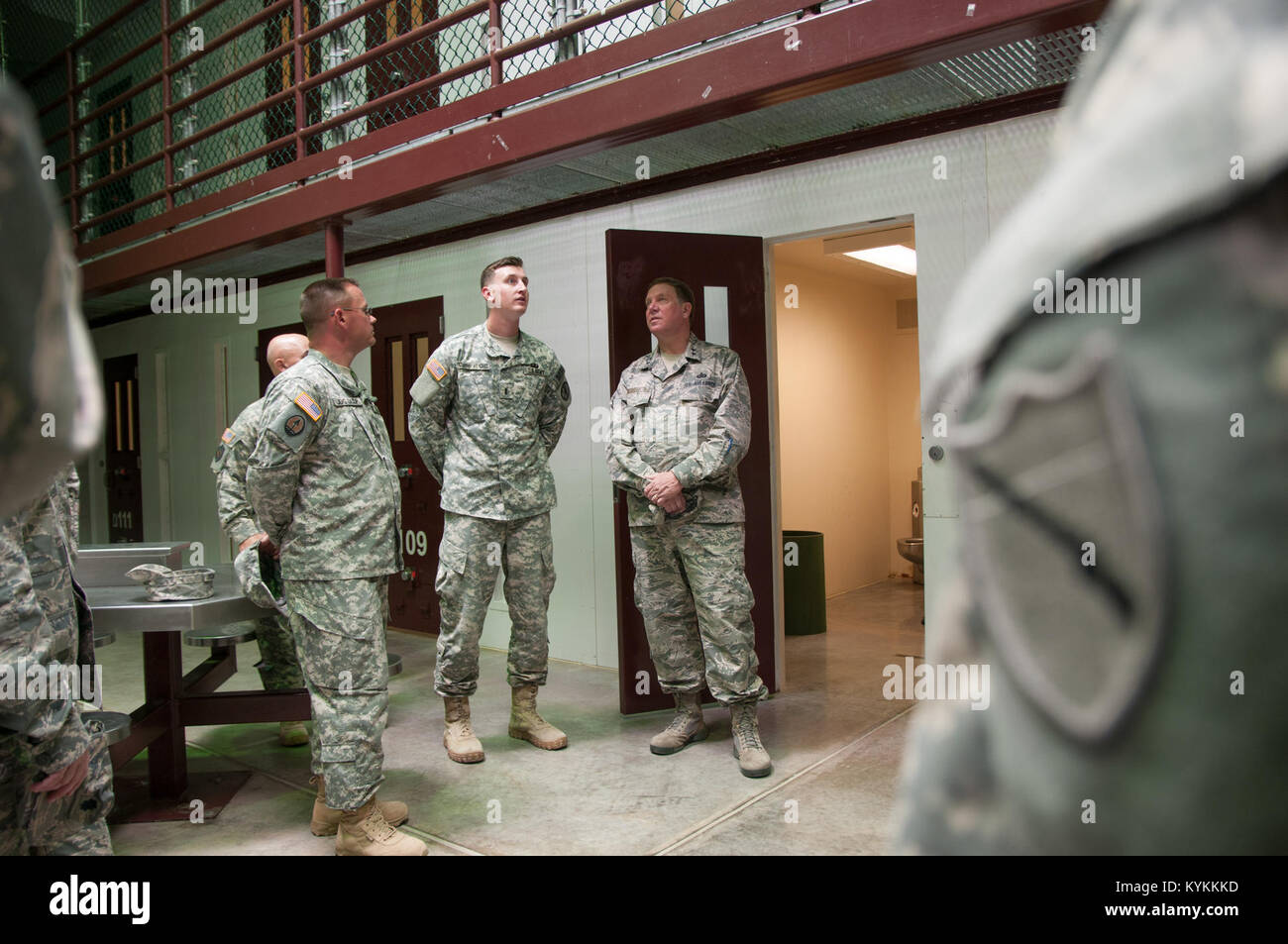 Air Force Maj. Gen. Edward Tonini, adjutant general for the state of Kentucky, is briefed about the use of communal areas, by Army 1 Lt. Joseph Smith, the assistant officer in charge of Camp V, inside Camp V at U.S. Naval Station Guantanamo Bay, Cuba Dec. 3, 2013. Tonini came to the island to visit with Kentucky Guardsmen deployed to GTMO in support of public affairs operations there. (Army National Guard photo by Sgt. David Bolton/133rd Mobile Public Affairs Detachment/Joint Task Force-GTMO Public Affairs) Stock Photo