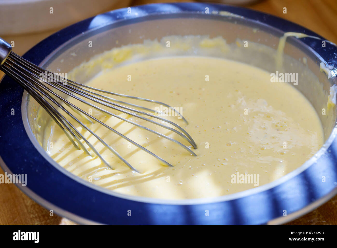 Mixing butter and sugar in bowl with mixing machine, making bakery mixing cream with mixer Stock Photo
