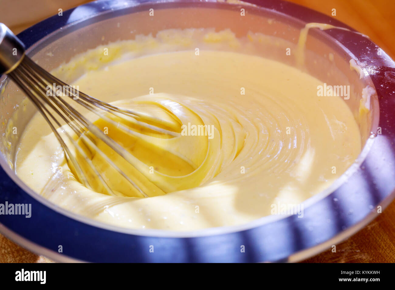 The process of whipping cream with a mixer. Mixer whiskers with cream