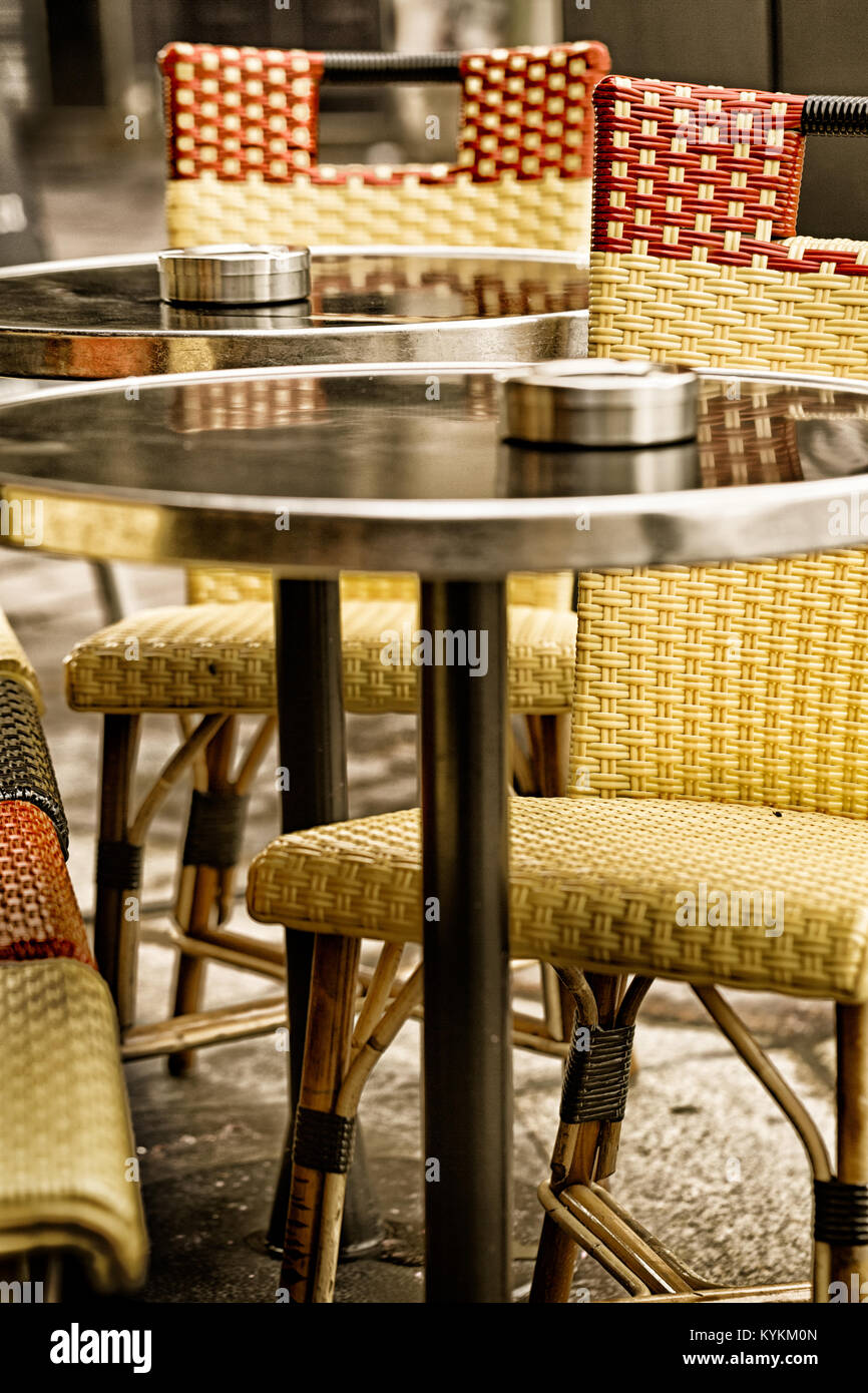 Paris sidewalk cafe classic bistro chairs and tables. Close up detail and vintage color. Stock Photo