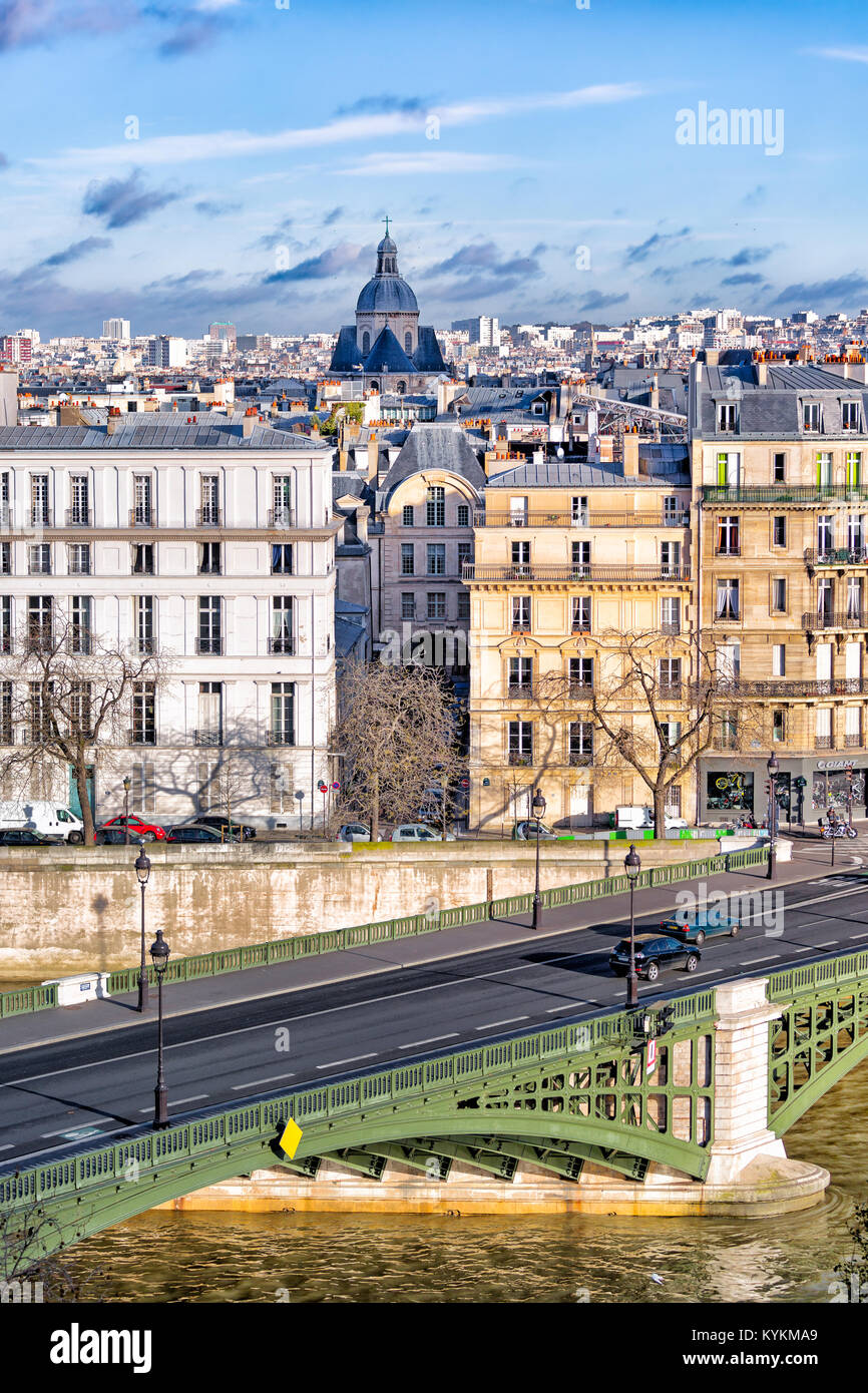 Paris, France view from the Left Bank over a Seine River bridge and the old Marais neighborhood. Beautiful light and blue sky on a crisp winter day. Stock Photo