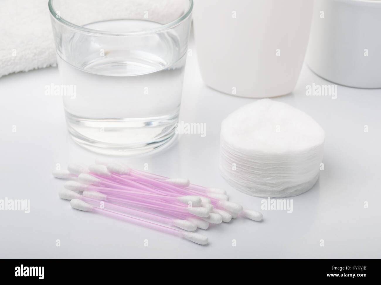 Hygiene  products - cotton pads and sticks, water, towel,  lotions on white background Stock Photo