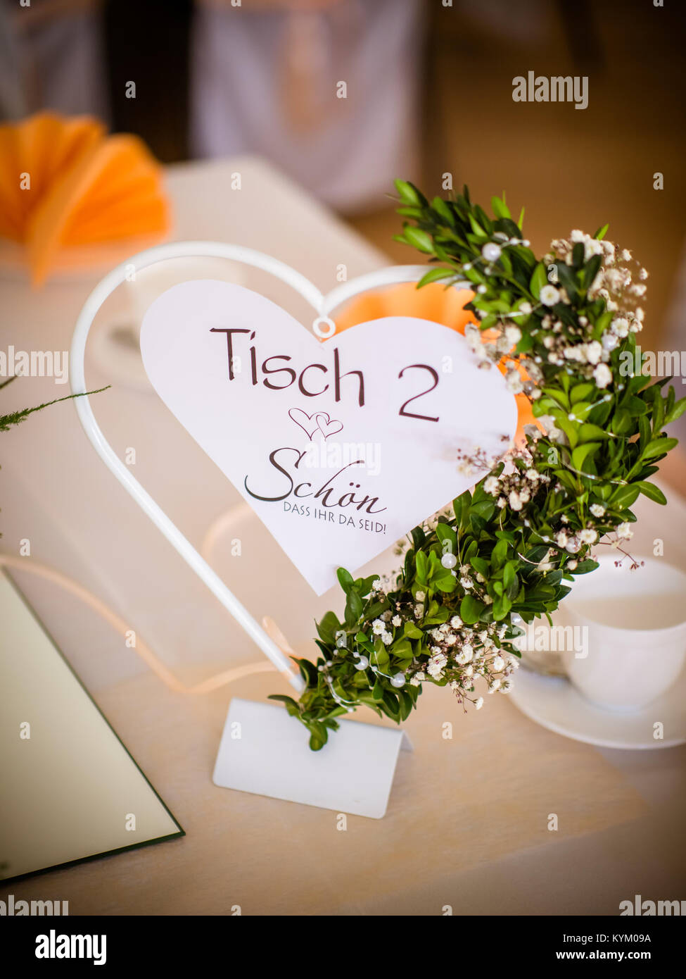 the table number on the wedding table with boxwood Stock Photo