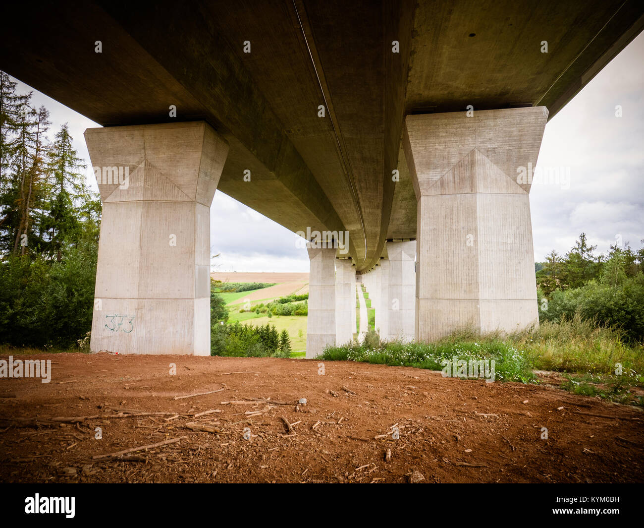 View of the bridge viaduct from below against the blue sky with clouds,Beneath the bridge in Germany Stock Photo