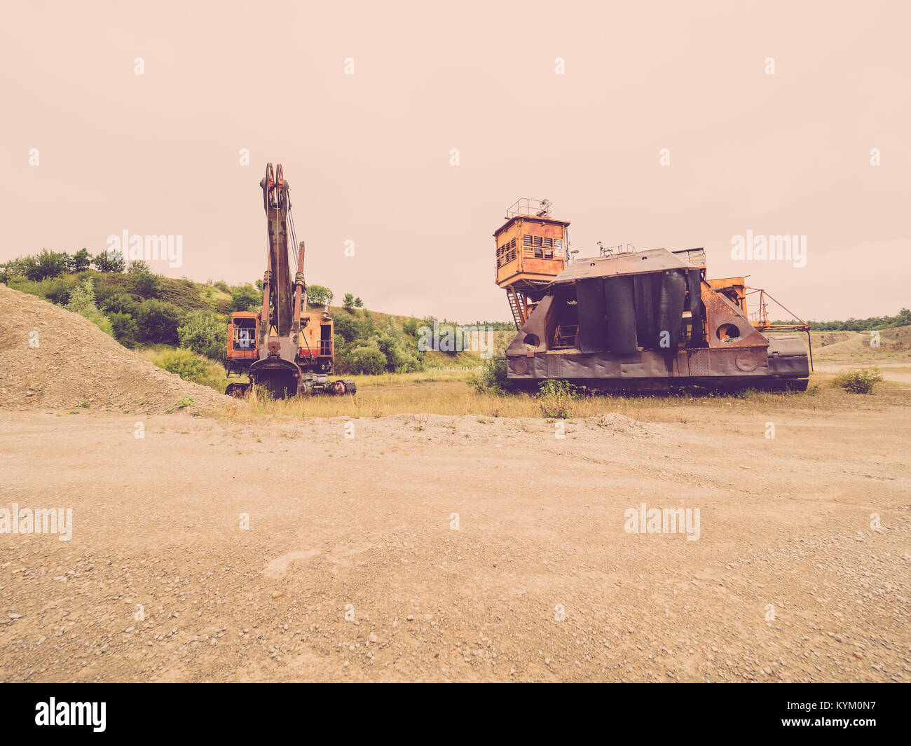 The open pit with old construction machines that are no longer in operation Stock Photo