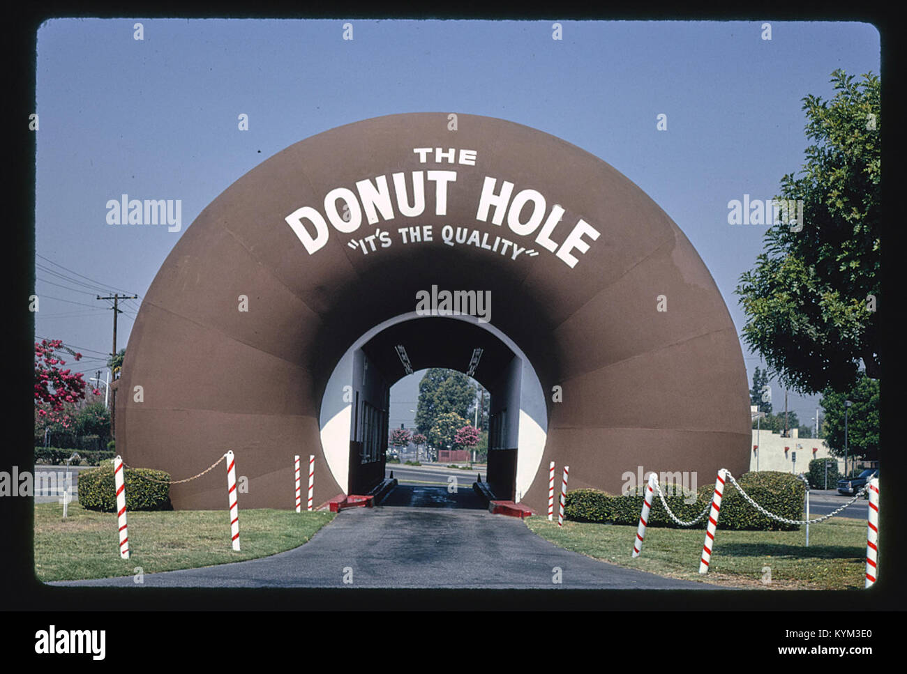 A photograph of the Donut Hole restaurant, captured from a straight-on view on Amar Road, Louisiana, featuring the iconic structure without any cars in the frame. Stock Photo