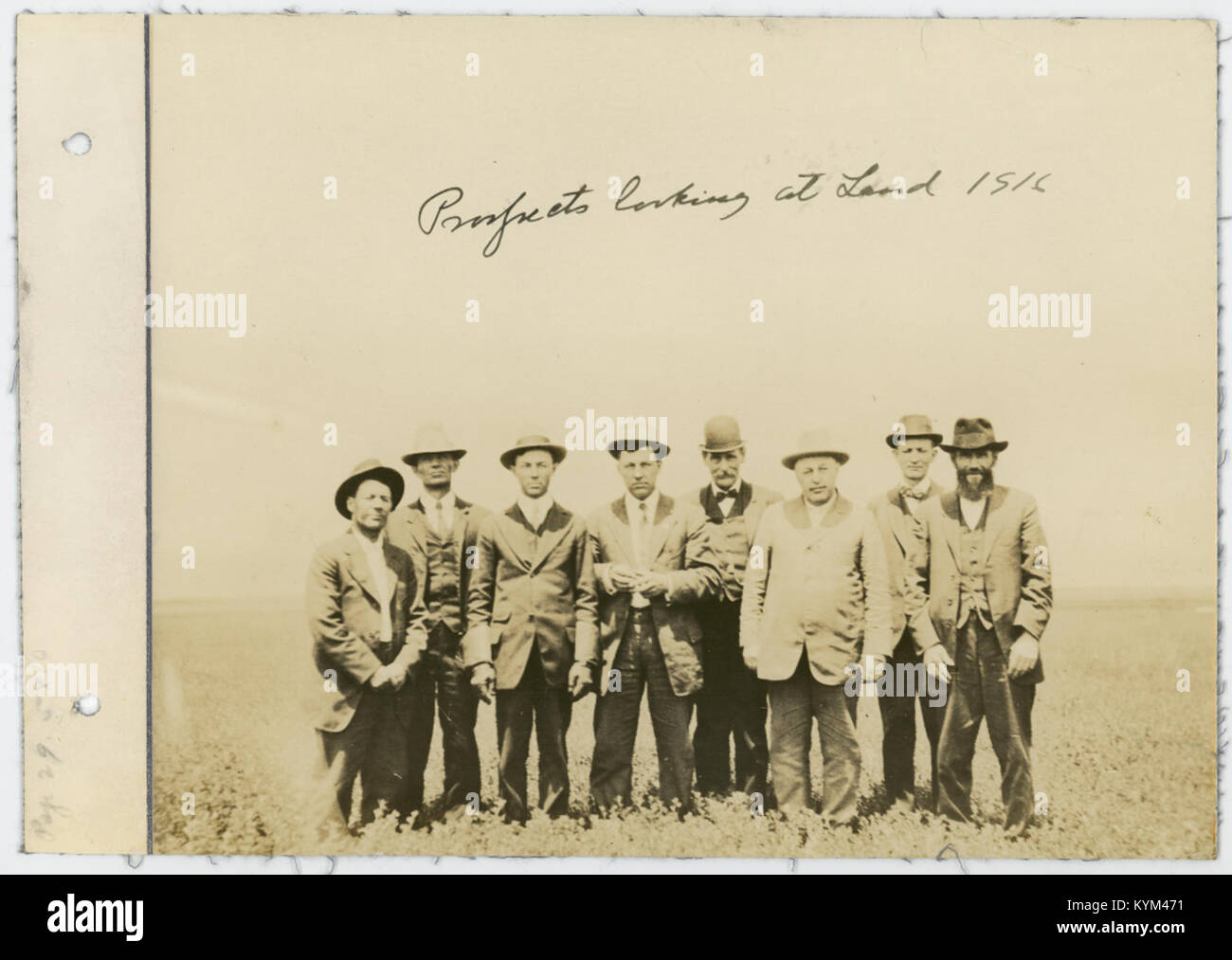 A historical photograph from 1916 showing a group of individuals looking at land, possibly as part of a land prospecting or agricultural development activity in early 20th century America. Stock Photo