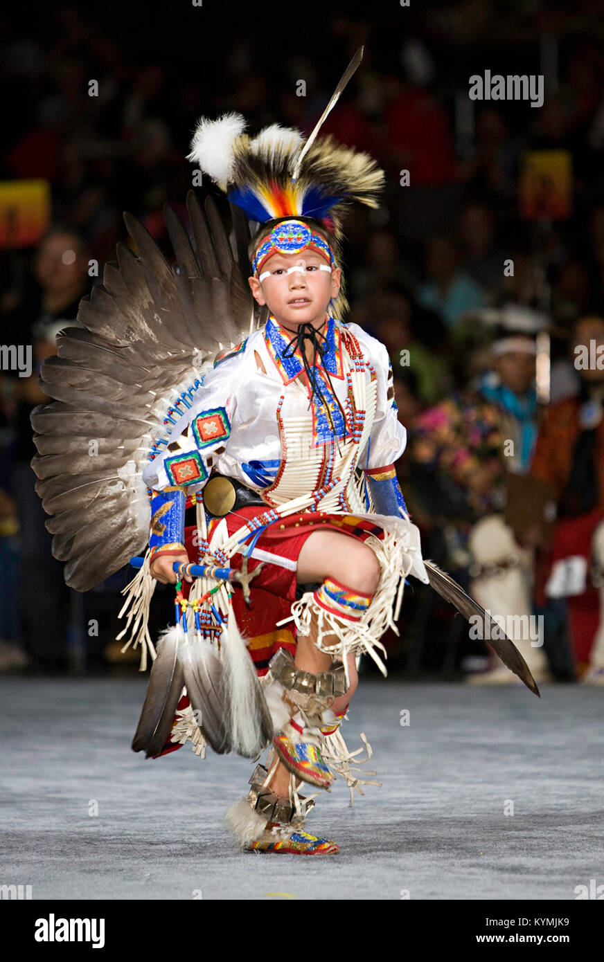 This image captures a Native American child dressed in traditional ...