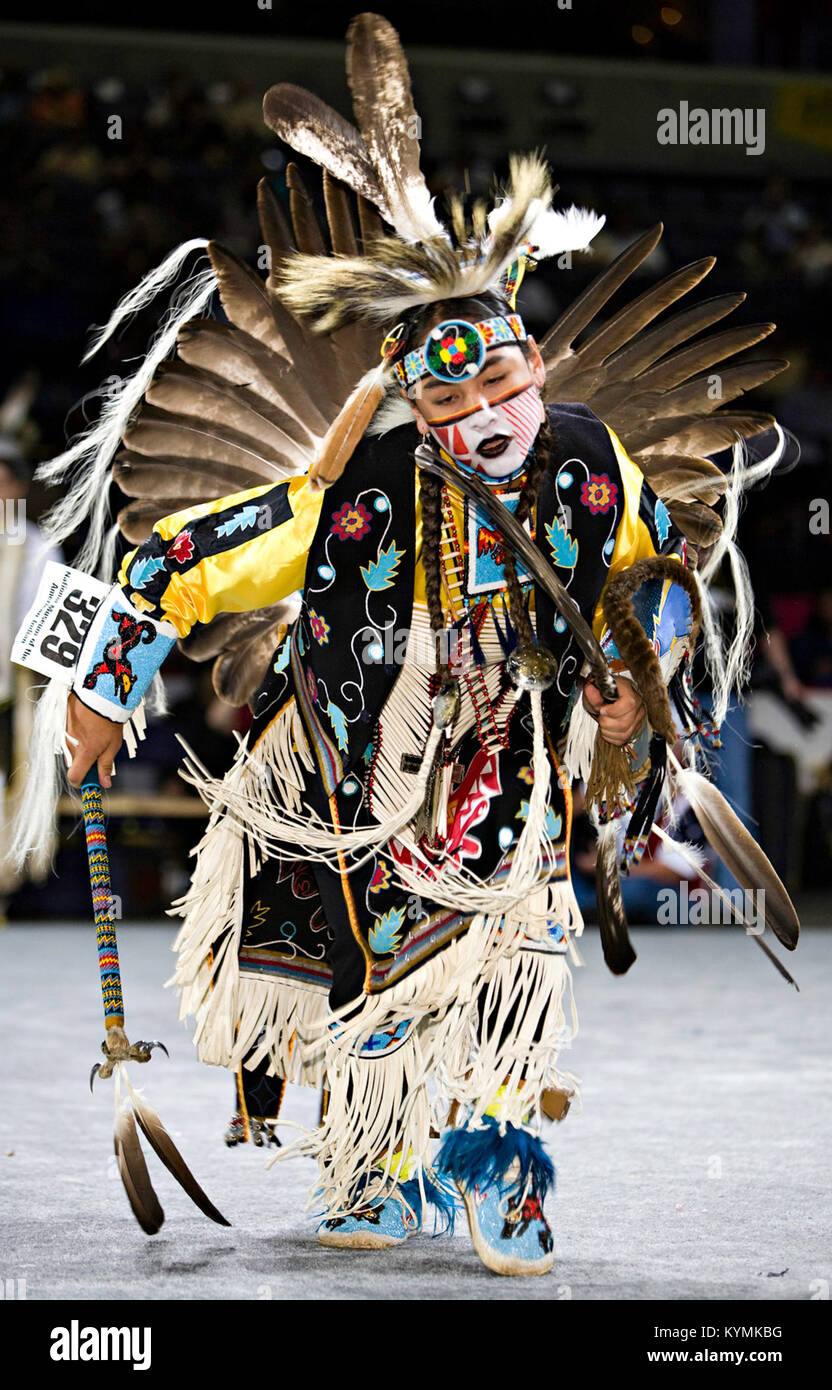 A traditional Native American dance at a powwow, with participants in ...
