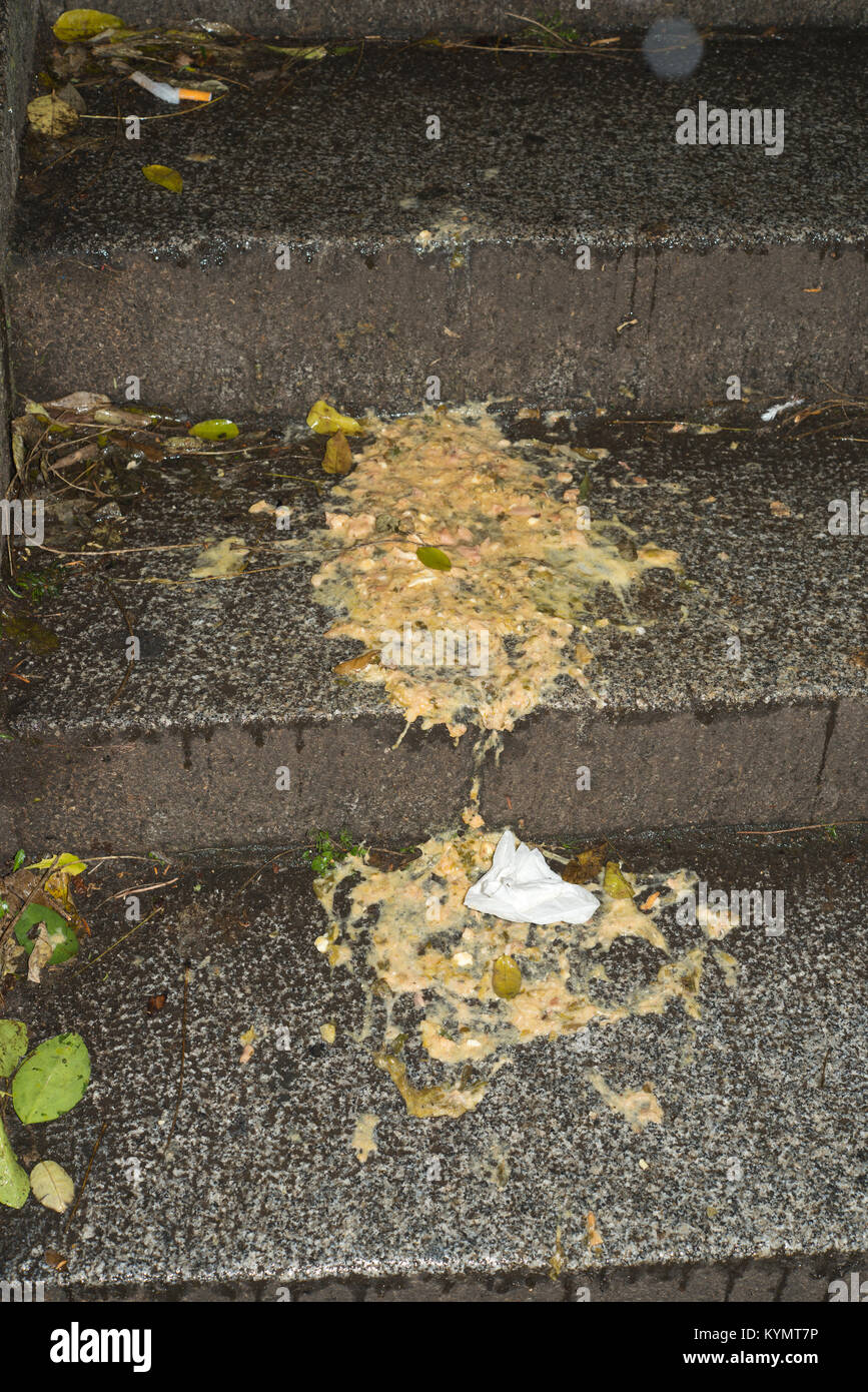 Human sick outdoors. Stomach contents spewed onto steps. Stock Photo