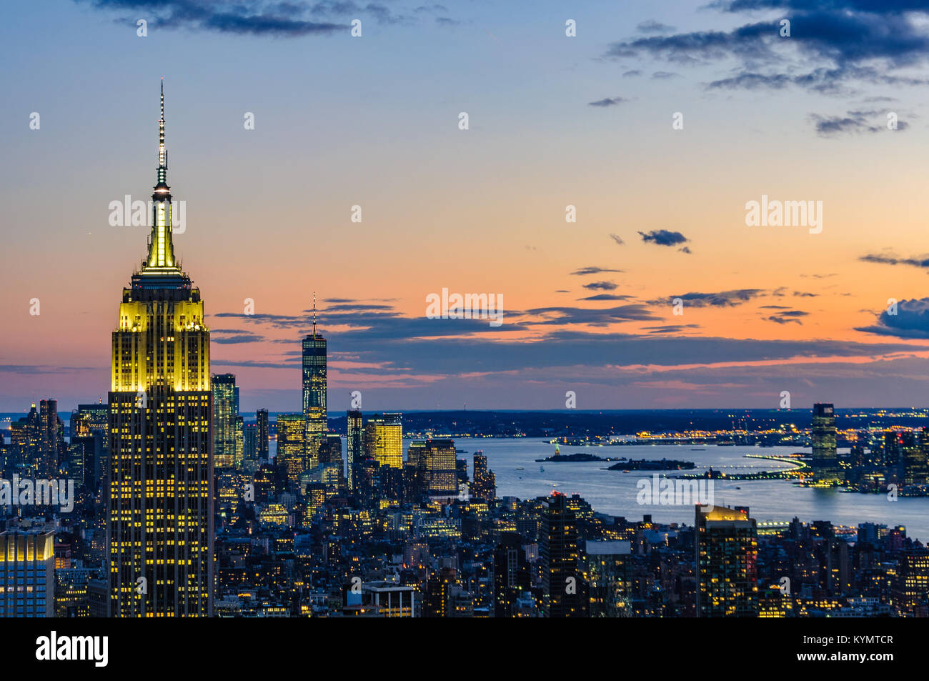 View of the city skyline and the Empire State Building at night from ...