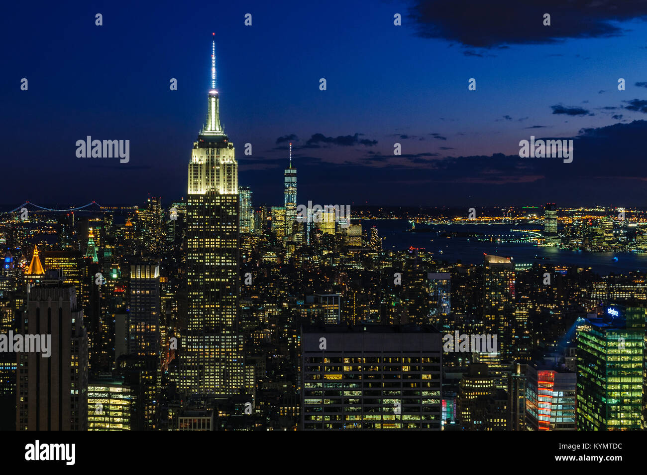 View of the city skyline and the Empire State Building at night from ...