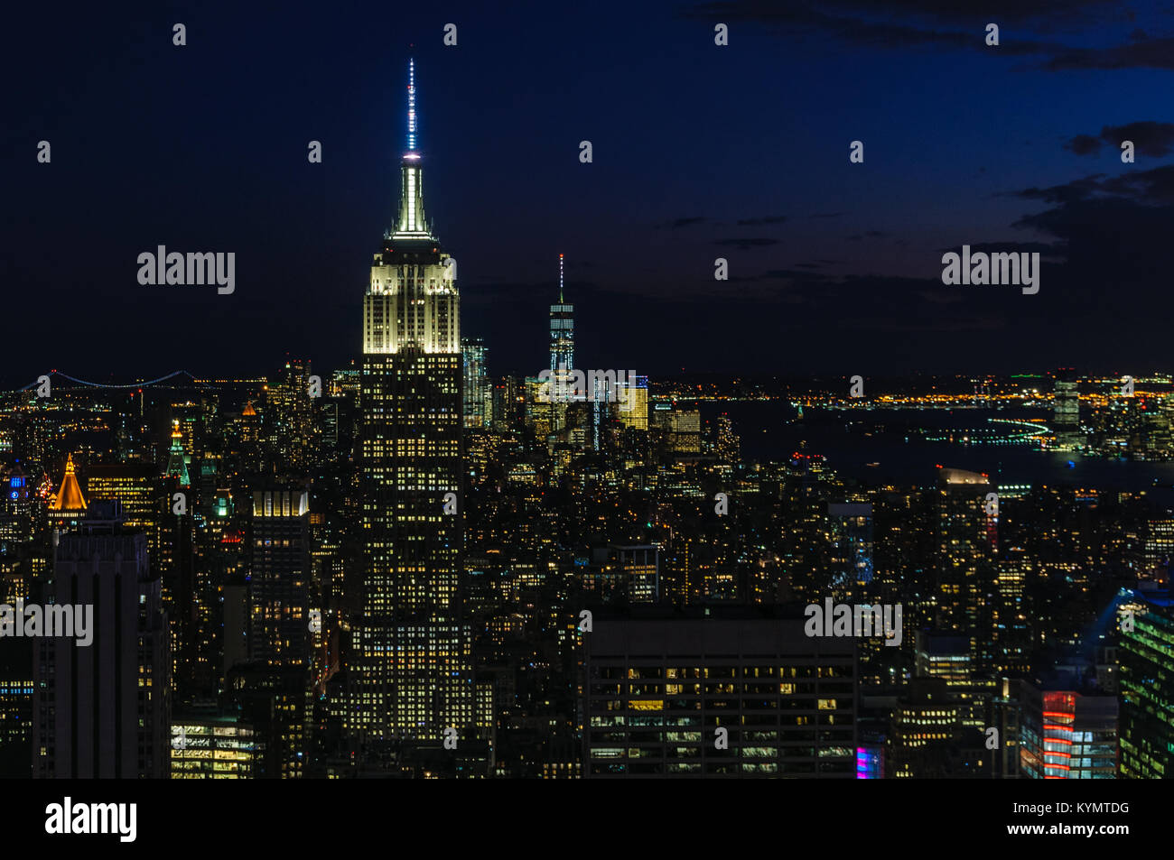 View of the city skyline and the Empire State Building at night from ...