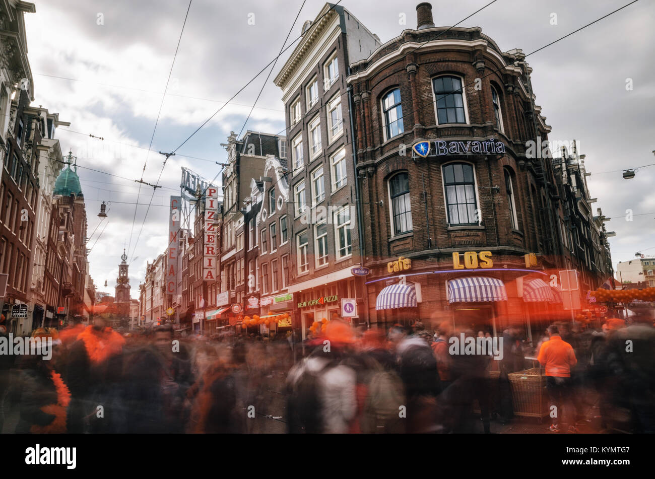 Amsterdam, Netherlands - 27 April, 2017: Streets of Amsterdam full of people in orange during the celebration of kings day with orange decorations. Stock Photo
