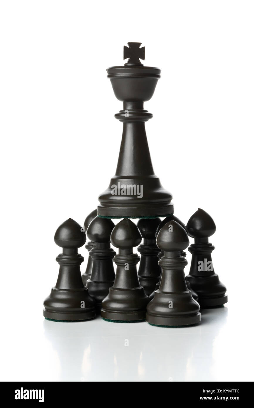 King chess figure standing on top of pawn chess figures - management, leadership, teamlead or strategy concept over white background Stock Photo