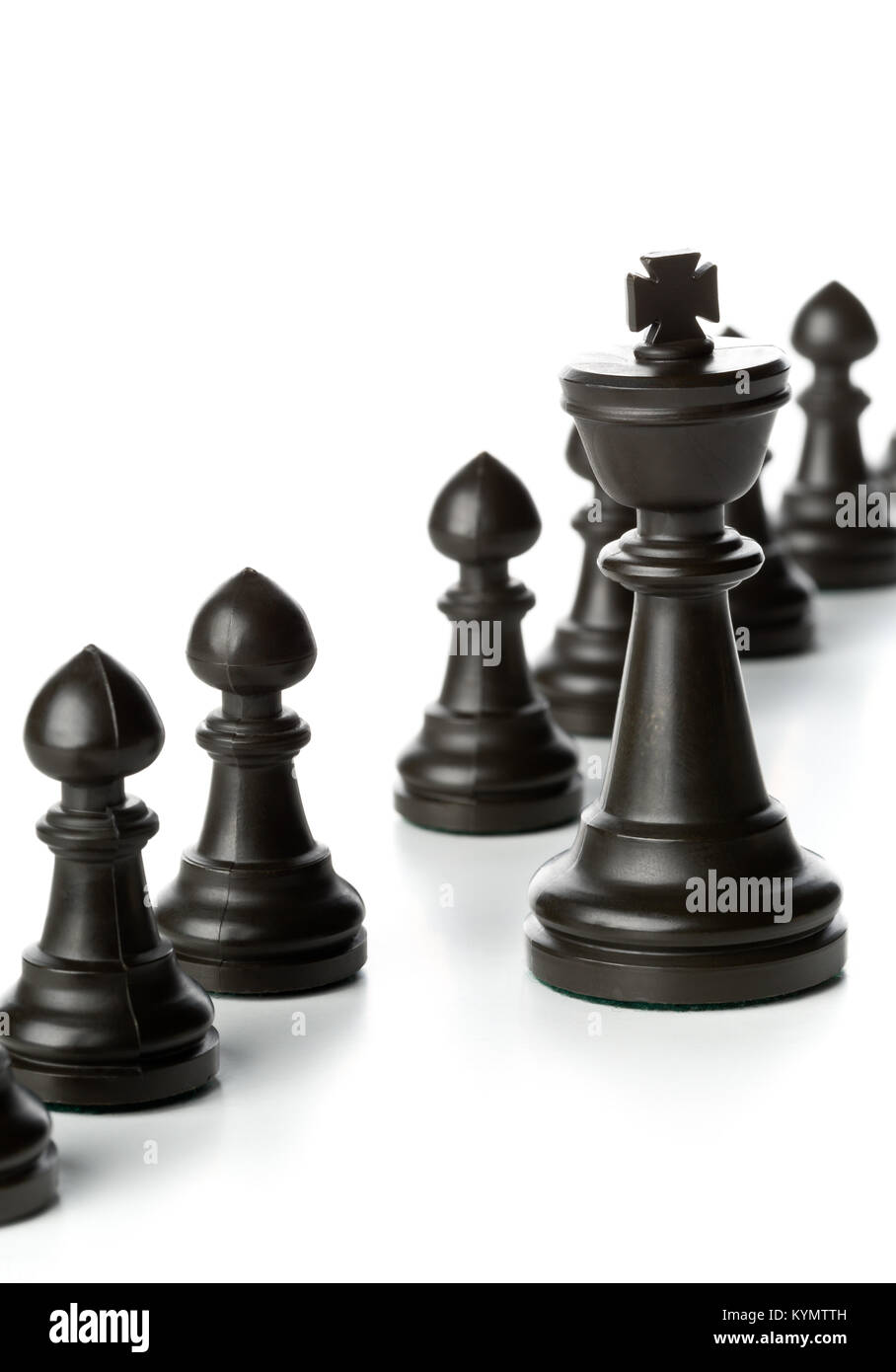 King chess figure in front of row of pawn chess figures - management, leadership, teamlead or strategy concept over white background Stock Photo