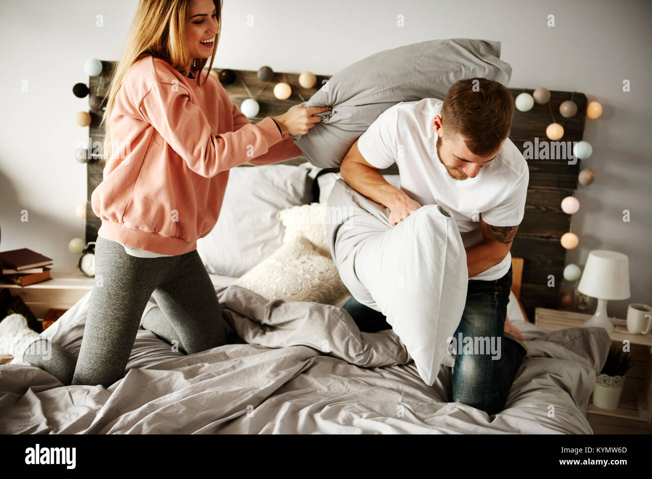 Cheerful couple during pillow fight Stock Photo Alamy