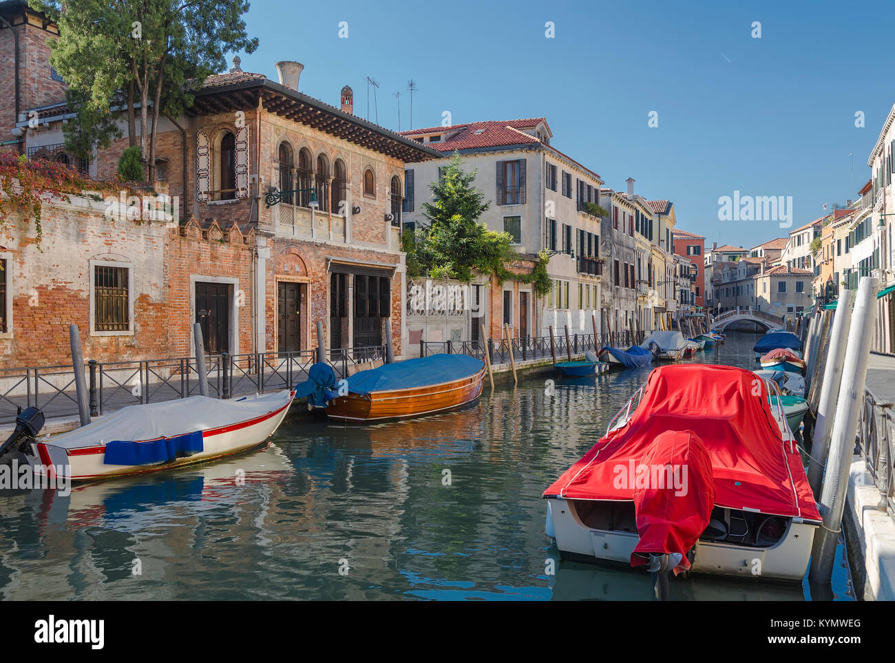 View of the canal with standing spoons and picturesque houses. Venice. Italy Stock Photo