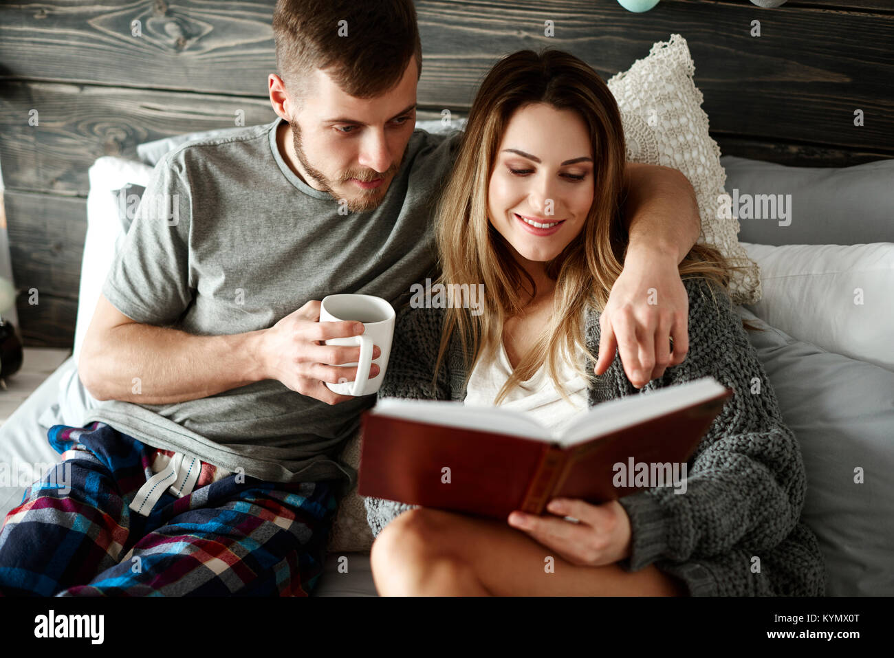 Affectionate couple spending time together at bedroom Stock Photo
