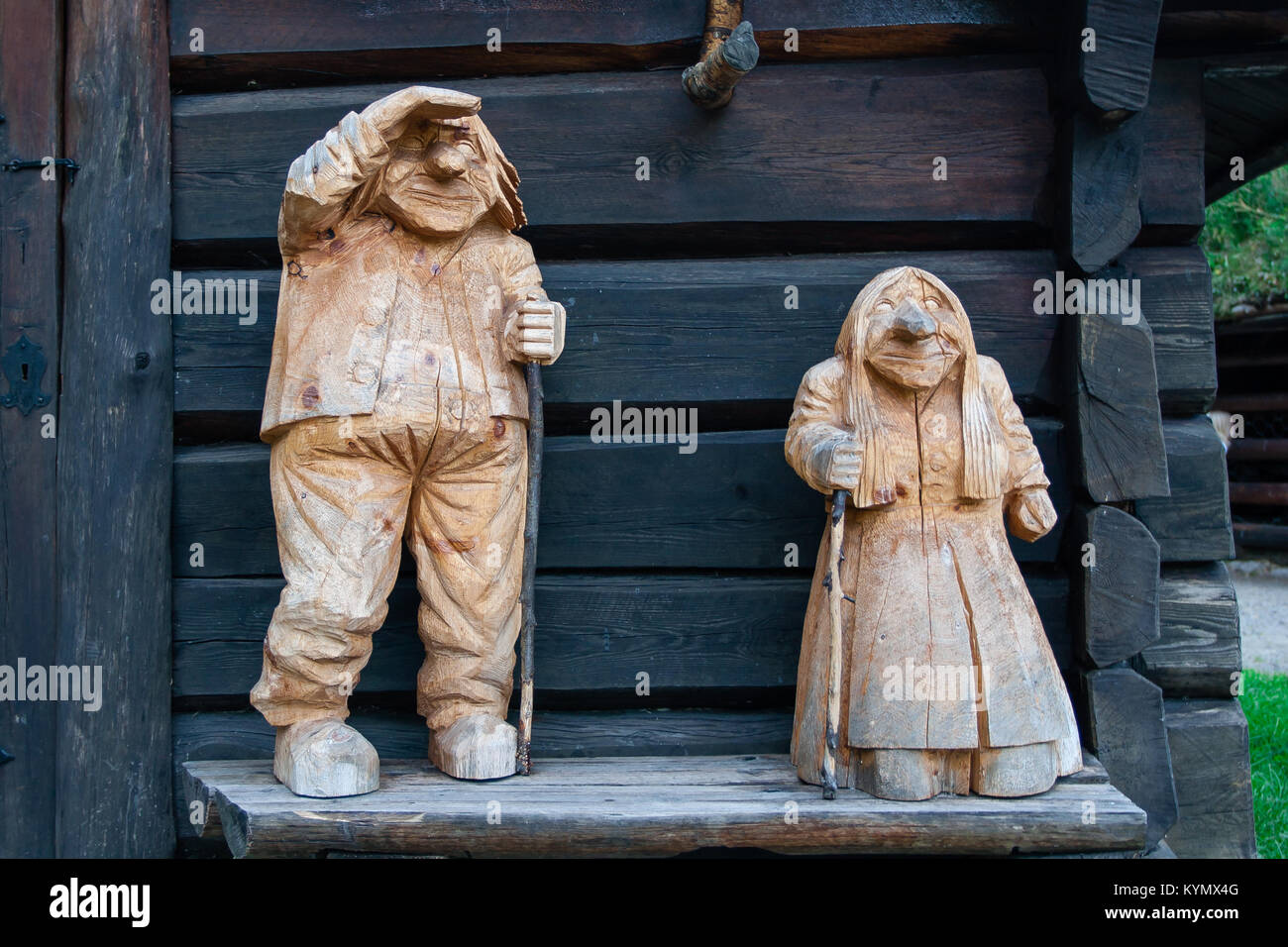 Carved in wood large statues of old couple man and woman trolls traditional folklore in Norway Stock Photo