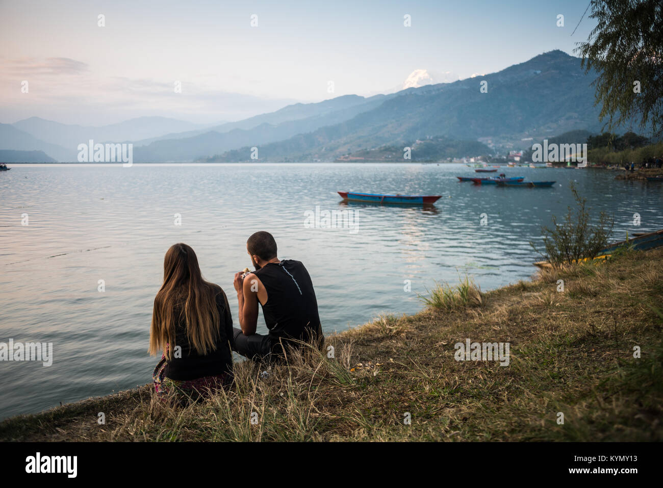 Tourists on the bank of the Phewa Lake in Pokhara, Nepal, Asia. Stock Photo