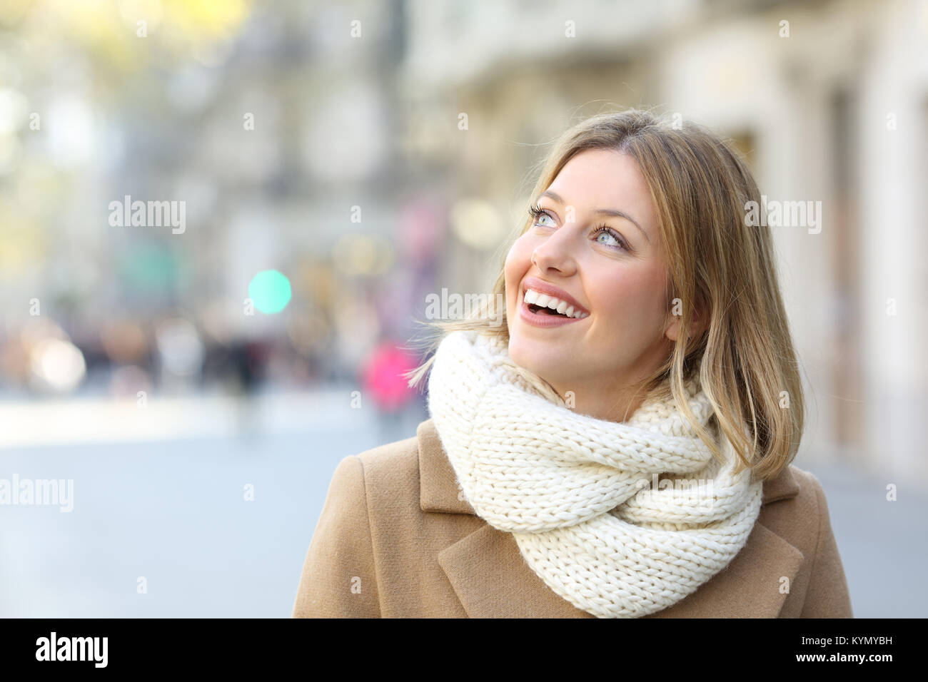 Portrait of a happy woman looking at side on the street in winter Stock Photo