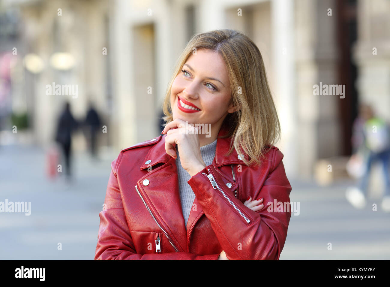 Front view portrait of a pensive girl looking at side on the street Stock Photo