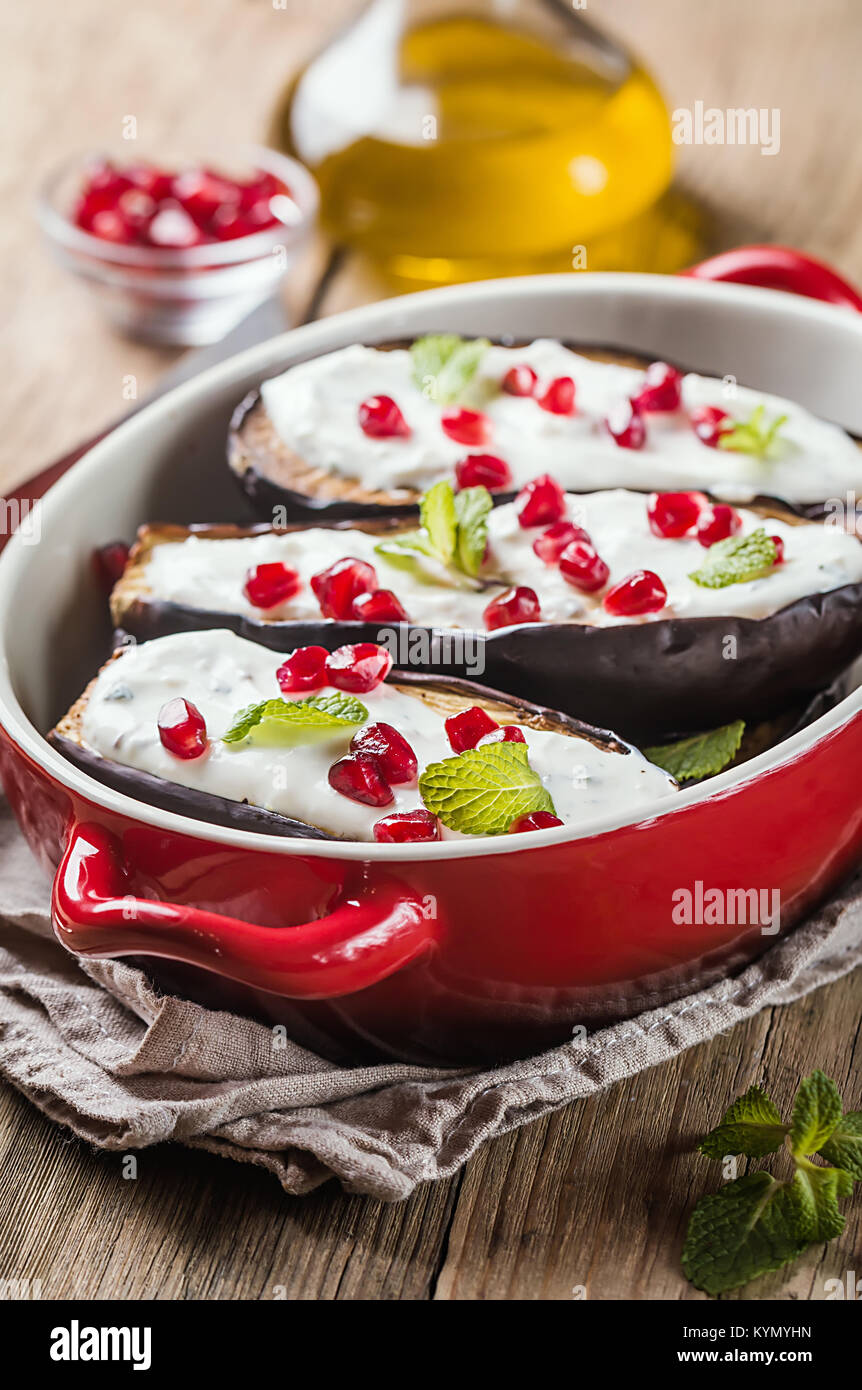 Grilled eggplants with garlic yogurt sauce and pomegranate in red form