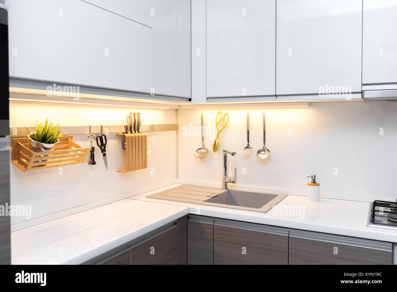 white gloss kitchen interior with worktop lighting Stock Photo