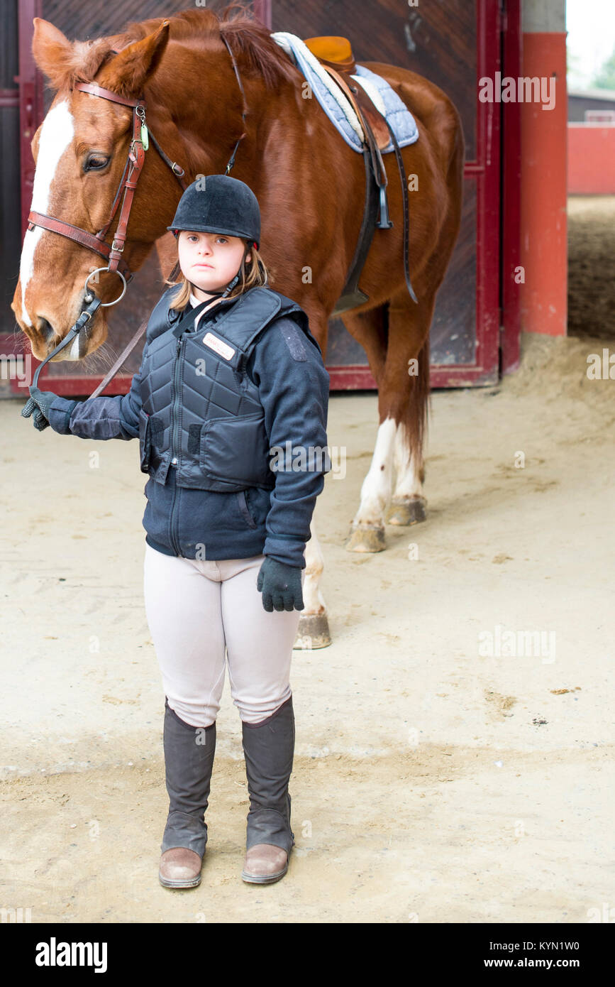 portrait of little girl with Down syndrome and his horse Stock Photo