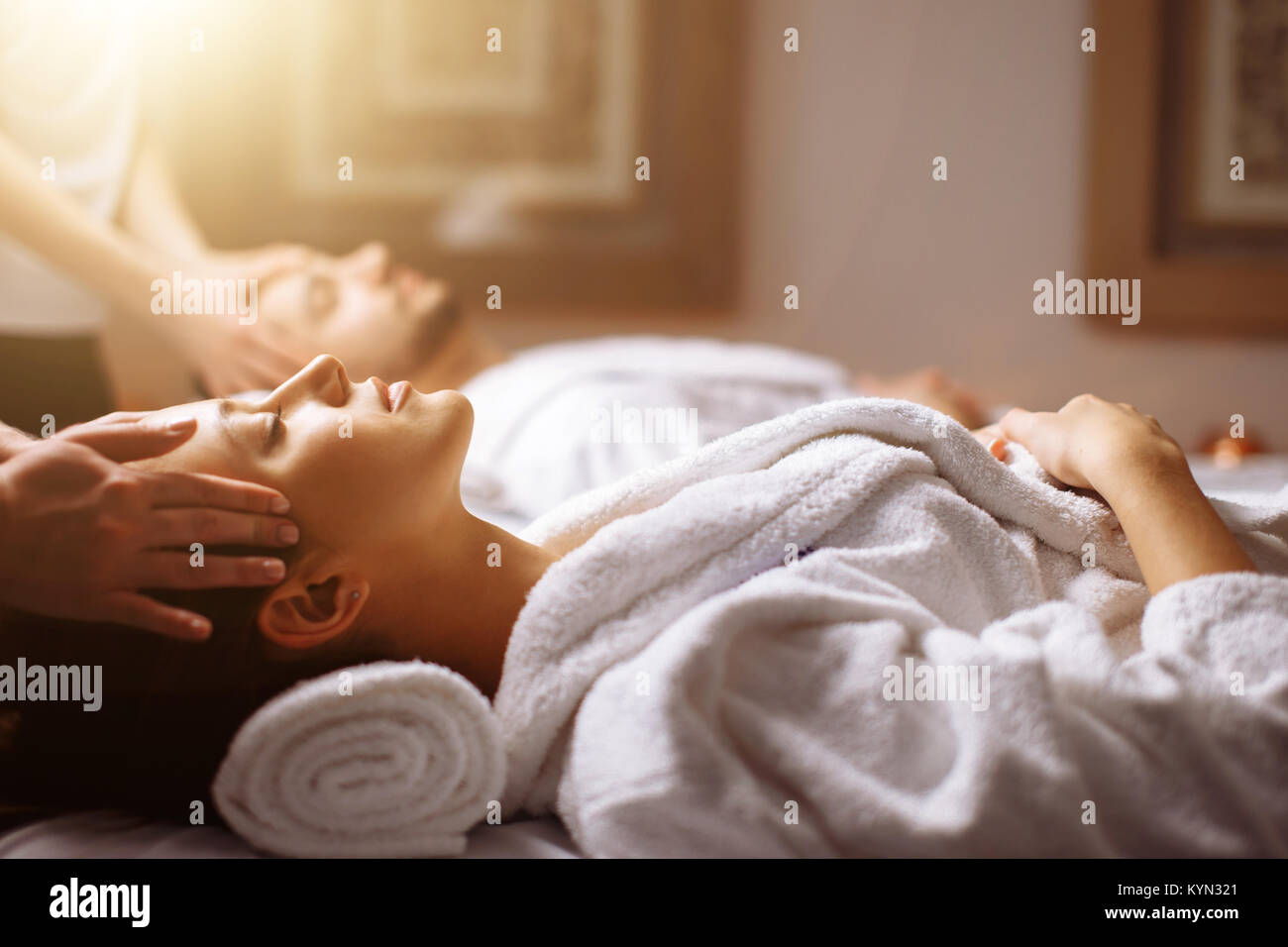Young couple receiving head massage at beauty spa Stock Photo