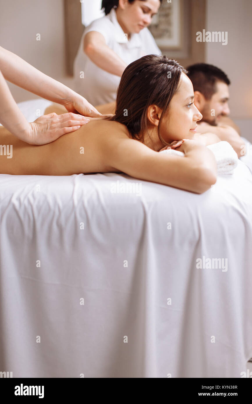 Happy couple getting massage at spa Stock Photo - Alamy