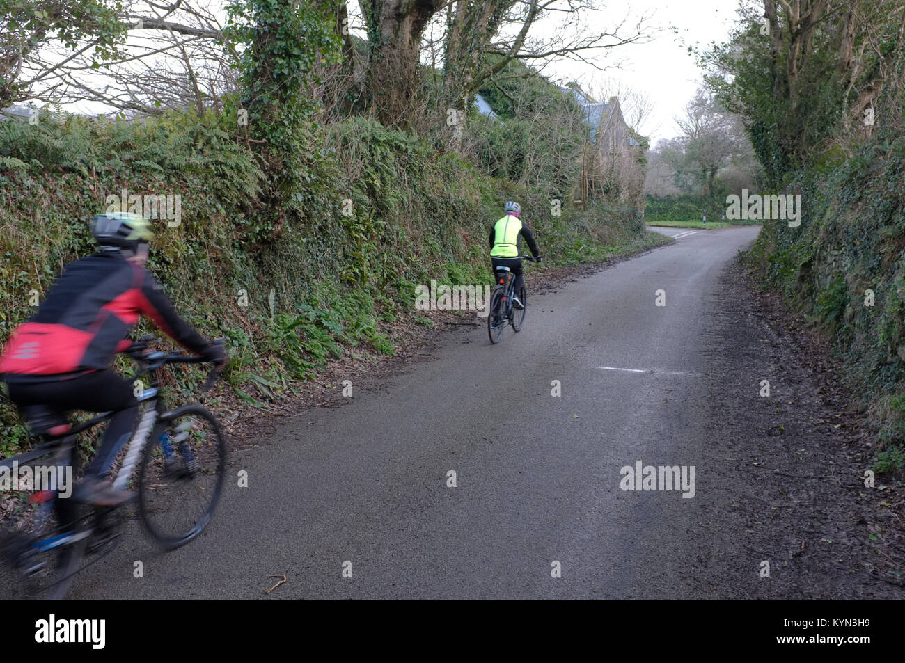 Two Cyclists on a small road in Cornwall. Stock Photo