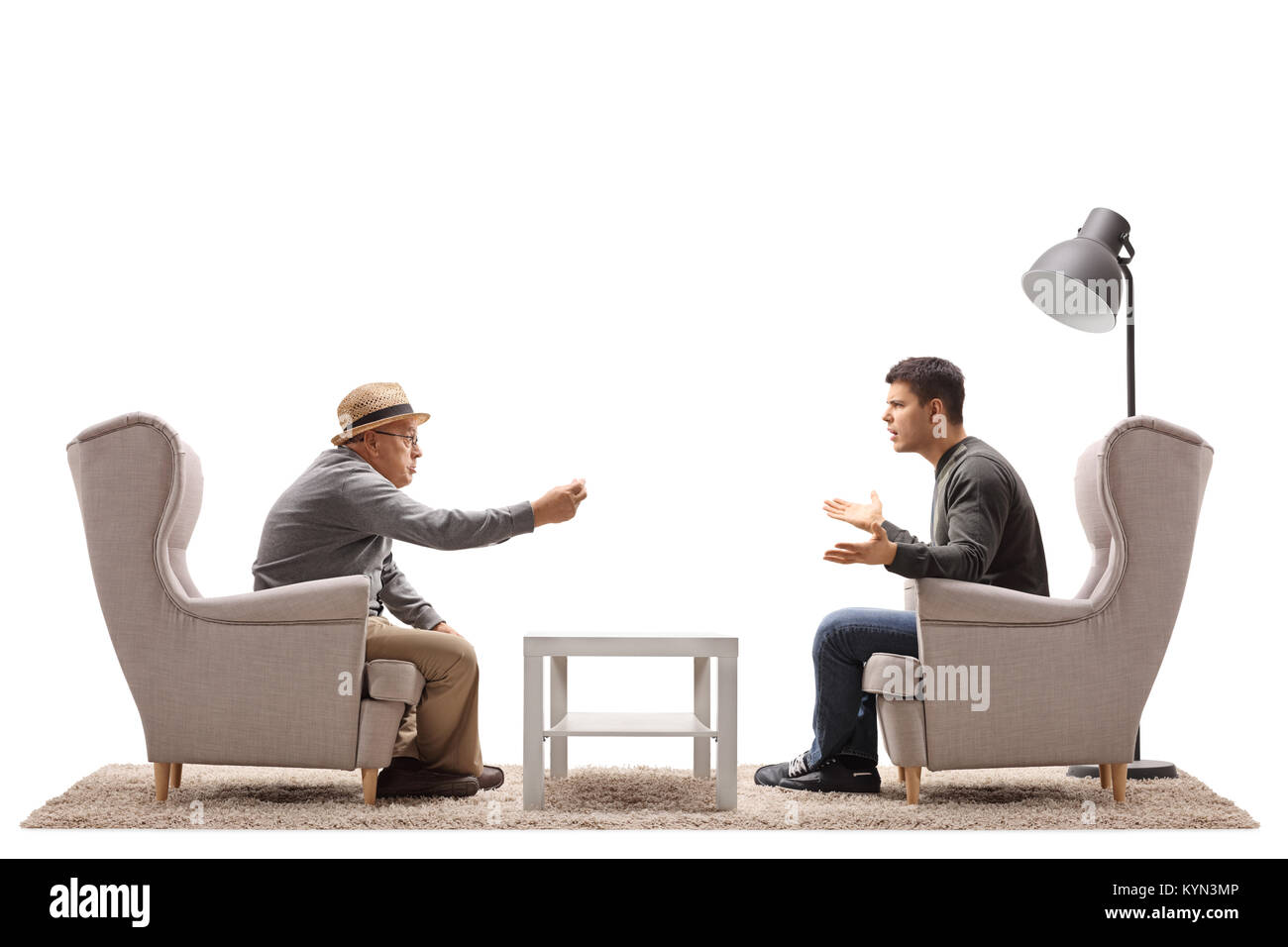 Mature man and a young guy seated in armchairs arguing isolated on white background Stock Photo