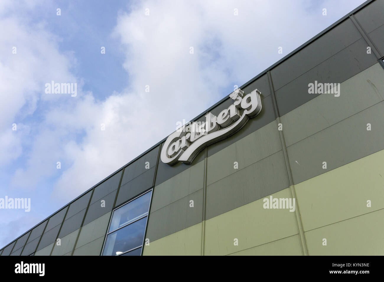 Carlsberg sign on top of The Cube, the bottling plant, at Carlsberg brewery, Northampton, UK Stock Photo