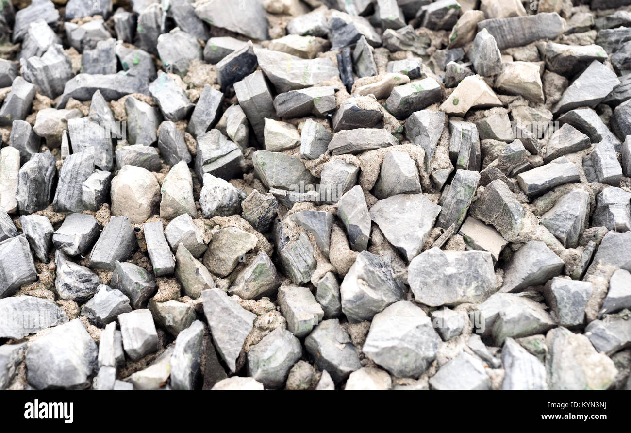 Grey triangle shaped rock chippings and stones in a triangle shapes with sharp edges used as a building exterior design feature Stock Photo