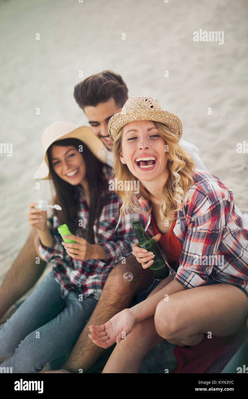 Group of cheerful friends having great time at beach Stock Photo