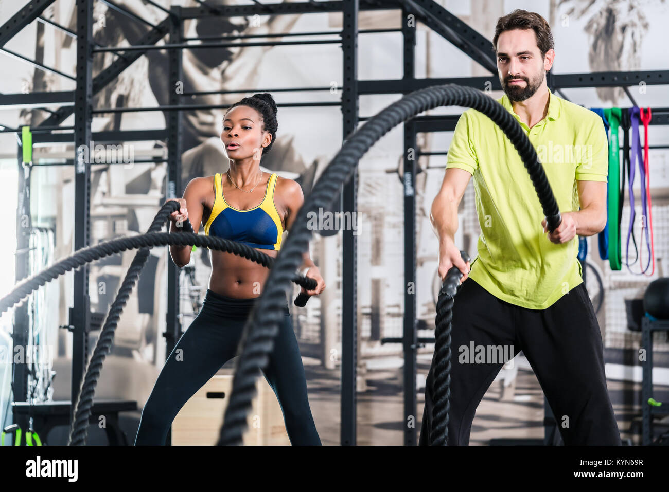 Functional training with battle rope in crossfit gym Stock Photo - Alamy